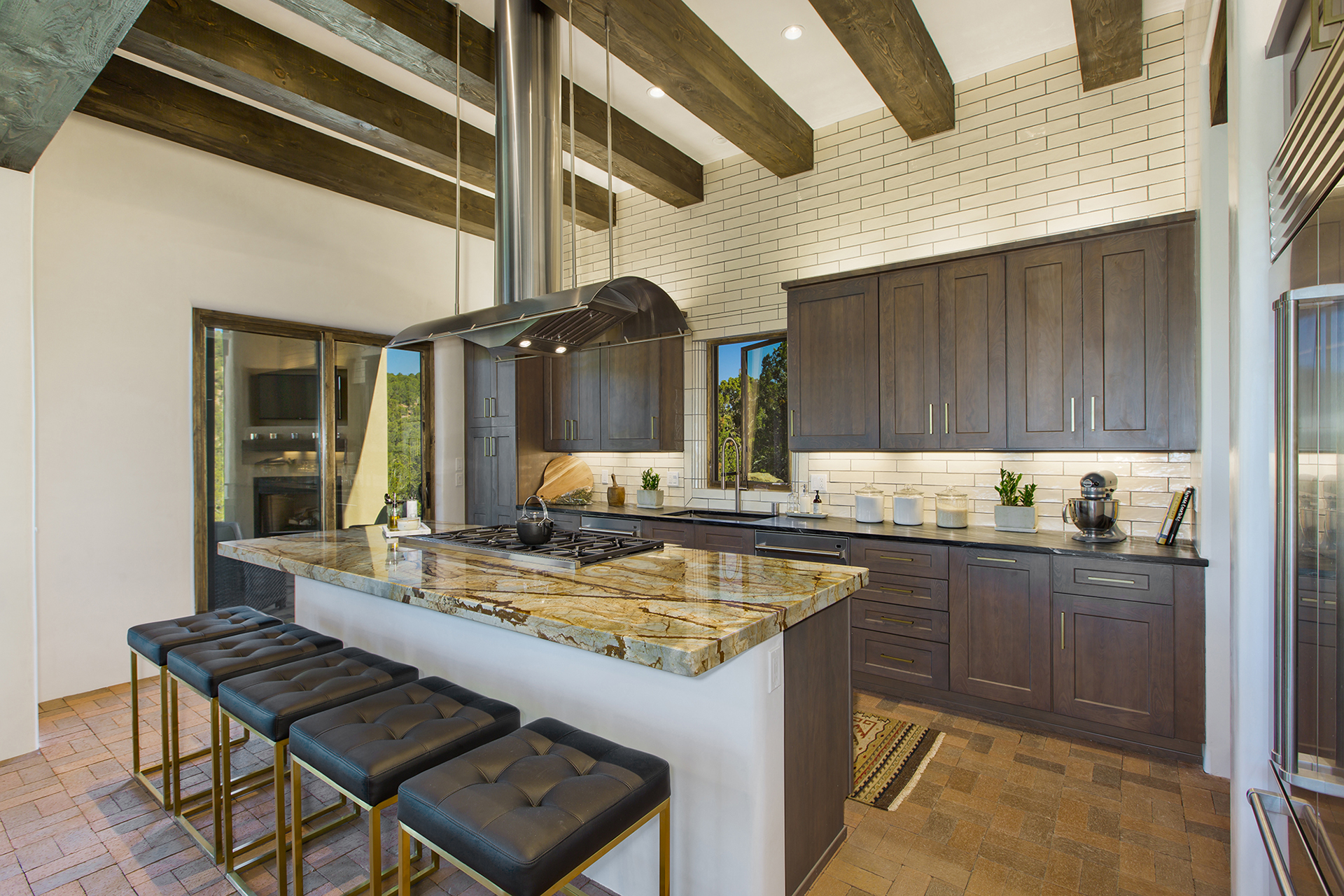 Santa Fe custom kitchen with stone island, dark wood cabinetry and exposed ceiling beams